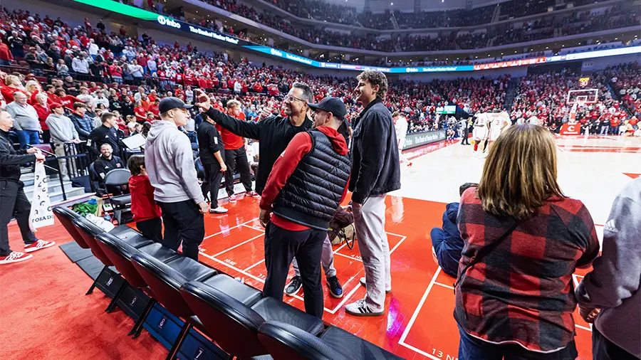 Fans standing courtside taking a selfie