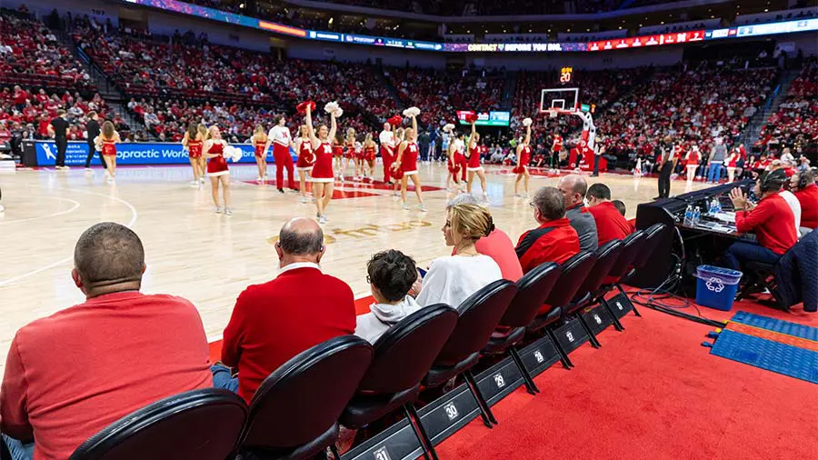 Fans sitting courtside watching the game