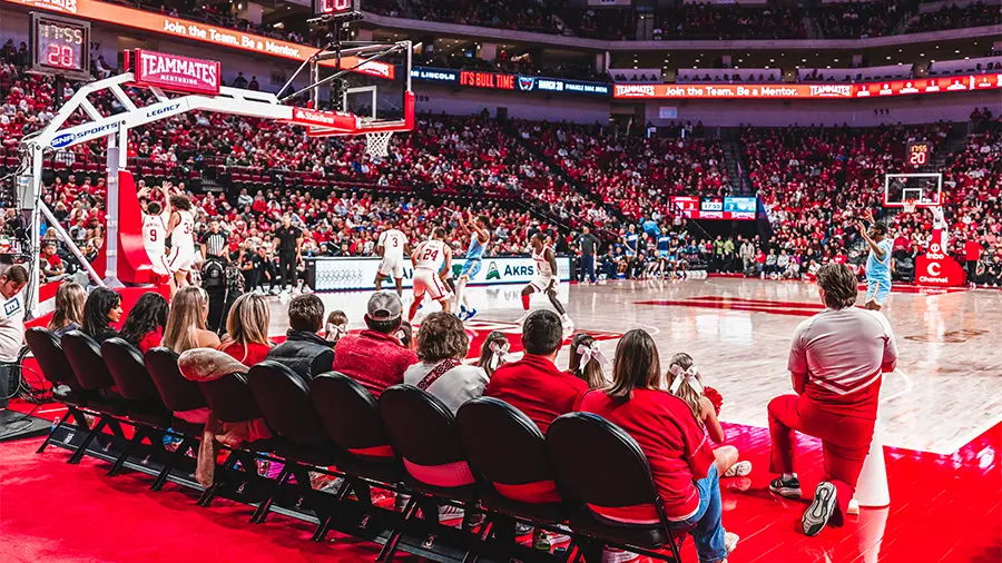Fans sitting courtside watching the game