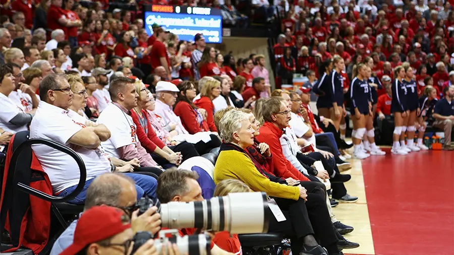 Fans sitting courtside watching game